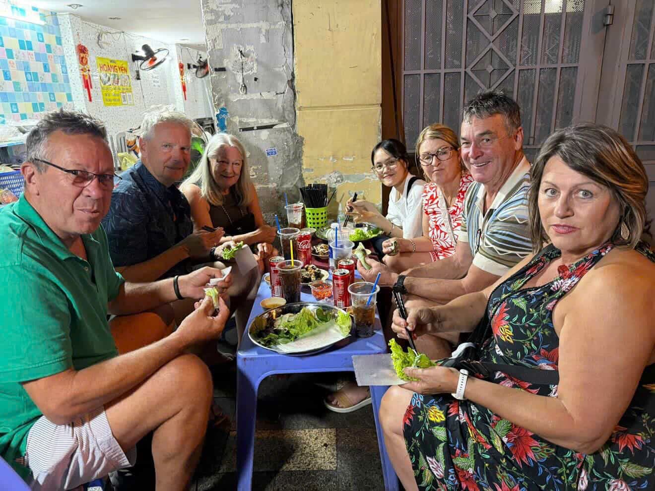 Group enjoying street food on a Saigon tour
